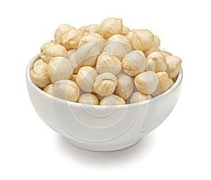 Bowl of peeled hazelnuts isolated on white background