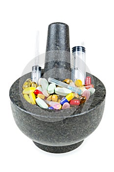 Bowl of pills and syringes addiction concept