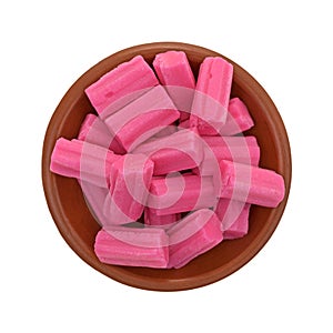 Bowl of pink bubble gum on a white background