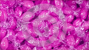 Bowl Of Pink Candies In Wrappers