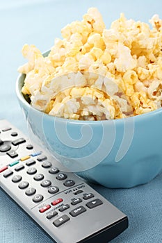 Bowl of popcorn and remote control