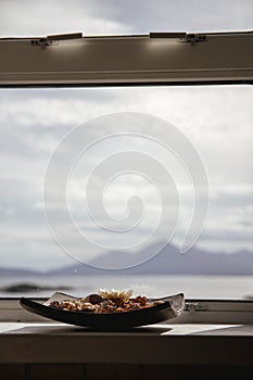 Bowl of pot pourri with landscape in the background lit by the s