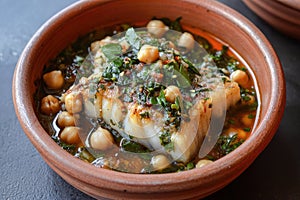A bowl of potaje de vigilia with cod and chickpeas