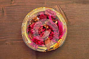 Bowl with potpourri on wood top view