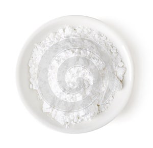 Bowl of powder sugar on white background, top view