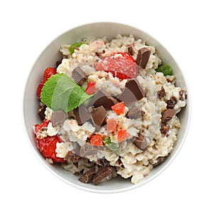 Bowl with prepared oatmeal, berries and chocolate on white background