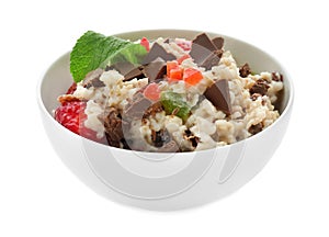 Bowl with prepared oatmeal, berries and chocolate on white background