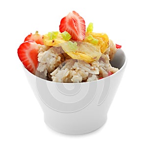 Bowl with prepared oatmeal, candied fruit and strawberry on white background