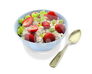 Bowl with prepared oatmeal, candied fruit and strawberry on white background