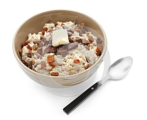 Bowl with prepared oatmeal, chocolate and raisins on white background