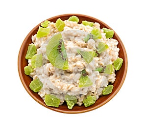 Bowl with prepared oatmeal and dried kiwi on white background