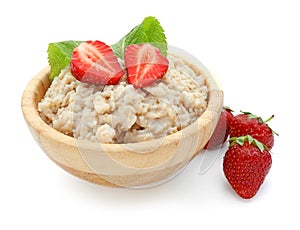 Bowl with prepared oatmeal and strawberry on white background