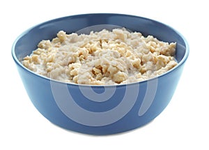 Bowl with prepared oatmeal on white background