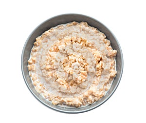 Bowl with prepared oatmeal on white background