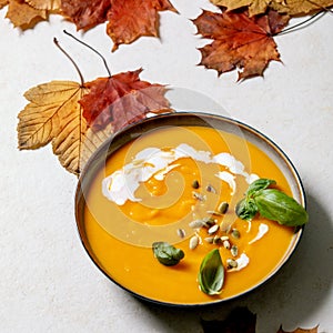 Bowl of pumpkin or carrot vegetarian cream soup