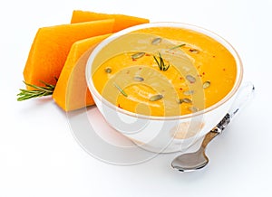 Bowl with pumpkin cream and pieces. Home and rustic appearance.