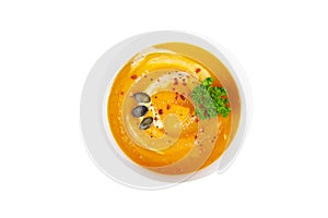 Bowl of pumpkin soup with a sprig of parsley