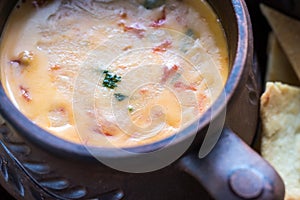 Bowl of queso with tortilla chips photo