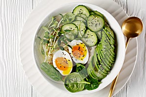 Bowl with quinoa, greens, avocado and boiled egg