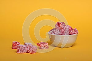 A bowl of rahat lakoum  on yellow background horizontal image. Turkish sweet concept