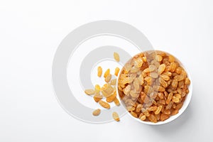 Bowl with raisins and space for text on white background, top view.