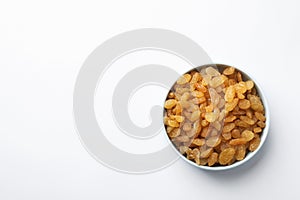 Bowl with raisins and space for text on white background, top view.