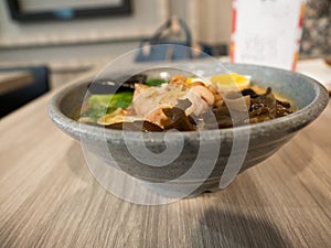 A bowl of ramen on a wooden table