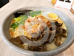 A bowl of ramen on a wooden table