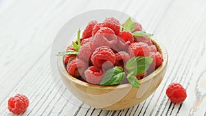 Bowl with raspberries and leaves