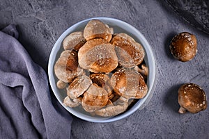 Bowl of raw Asian edable and medicinal shiitake mushrooms