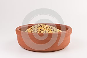 Bowl of raw bulgur and quinoa on white