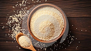 Bowl of raw couscous on a wooden background. Concept of Mediterranean cuisine, simple ingredients, and healthy grains