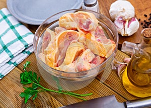 Bowl with raw sliced chicken, food preparation