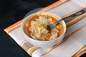 the bowl with raw soup with cut zucchini pasta zoodles or noodles and tomatoes