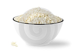 Bowl of raw white rice, isolated on white background