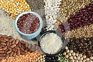 Bowl with raw white rices and beans on various seeds grain