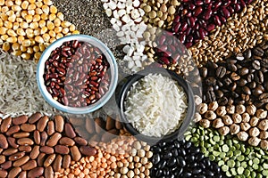 Bowl with raw white rices and beans on various seeds grain