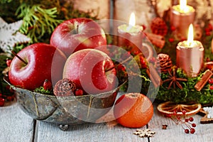 Bowl with red apples among Christmas decorations