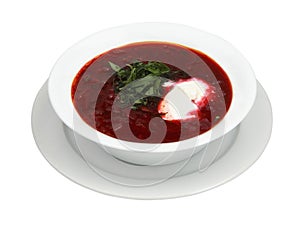 Bowl of red beetroot soup borsch on white round plate. Isolated