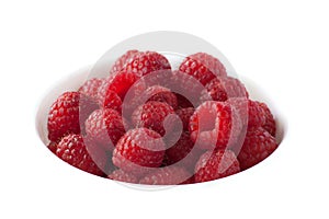 A bowl of red raspberries on a white background