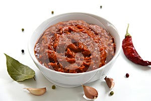 A bowl of red sauce, closeup, spices, and hot chili pepper