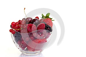 Bowl of red summer fruits or berries. photo