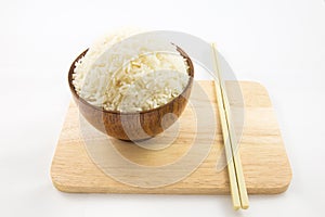 Bowl of rice and chopsticks on wooden