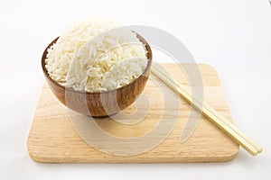 Bowl of rice and chopsticks on wooden