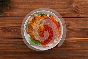 A bowl of rice topped with sea urchin and salmon roe, seafood representative of Hokkaido, Japan. Uni Ikura Donburi