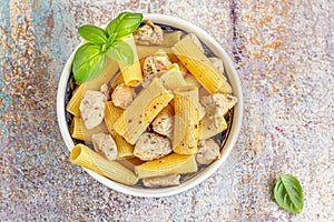 A bowl of rigatoni pasta with chicken