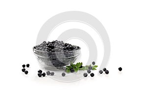 Bowl with ripe berries wild bilberries with leaves on a white background