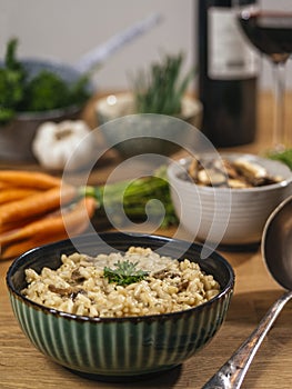 Bowl of Risotto on a table with ingredients