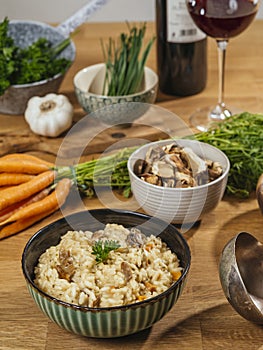 Bowl of Risotto on a table with ingredients