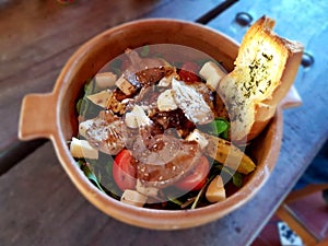 Bowl with salad and a piece of bread